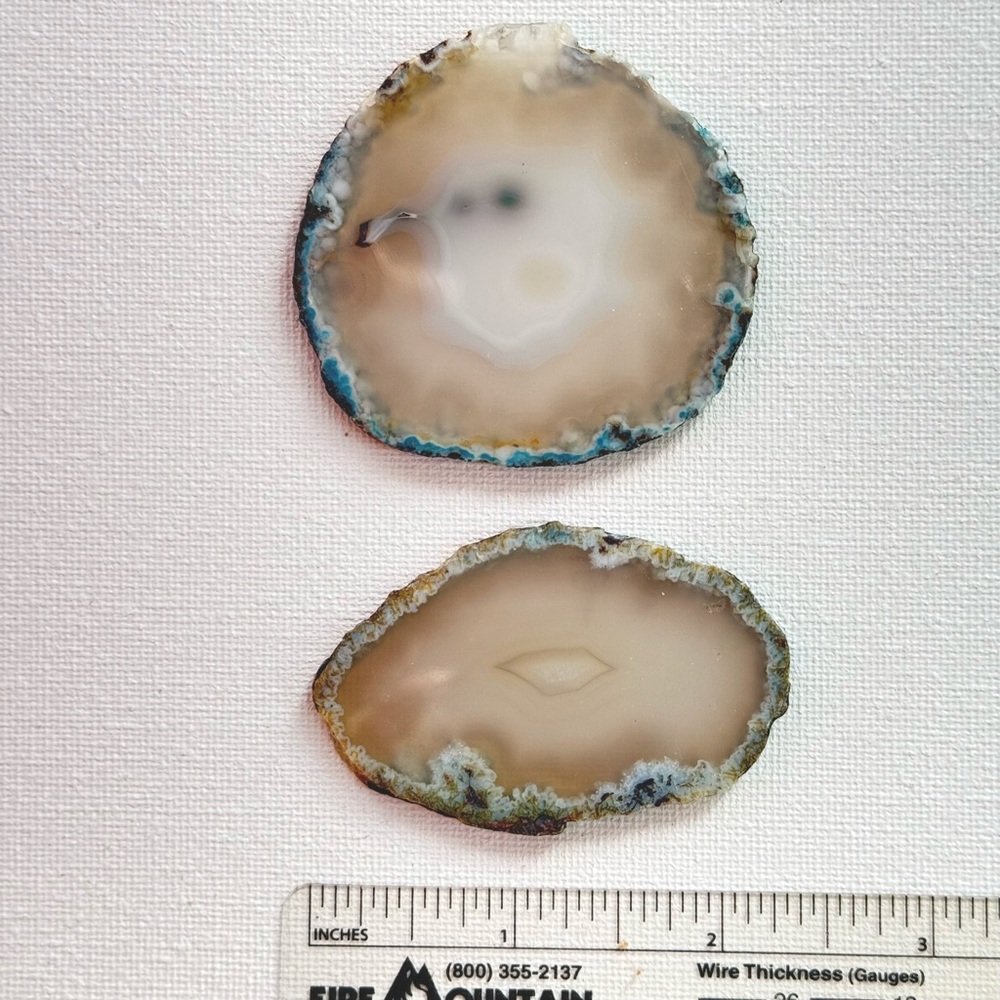Polished agate slices, two light brown tone slices.